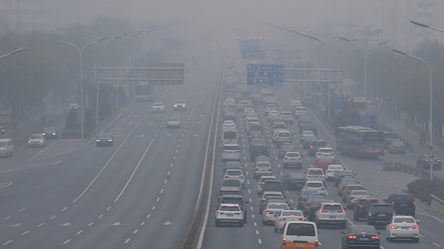 Vehicles are seen as heavy smog blankets China's capital after the city issued its first air pollution alert for the winter season, in Beijing, China.