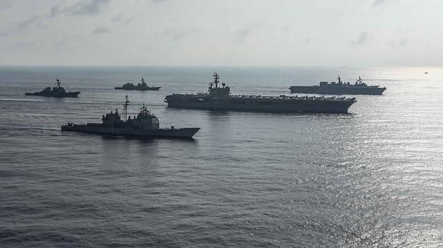 The Ronald Reagan Strike Group ship's the aircraft carrier USS Ronald Reagan (CVN 76), the guided-missile cruiser USS Antietam (CG 54) and the guided-missile destroyer USS Milius (DDG 69) conduct a photo exercise with the Japan Maritime Self-Defense Force ship's the helicopter destroyer JS Kaga (DDH 184), the destroyer JS Inazuma (DD 105) and the destroyer JS Suzutsuki (DD 117) in the South China Sea August 31, 2018. Mass Communication Specialist 2nd Class Kaila V. Peter/U.S. Navy/Handout via REUTERS
