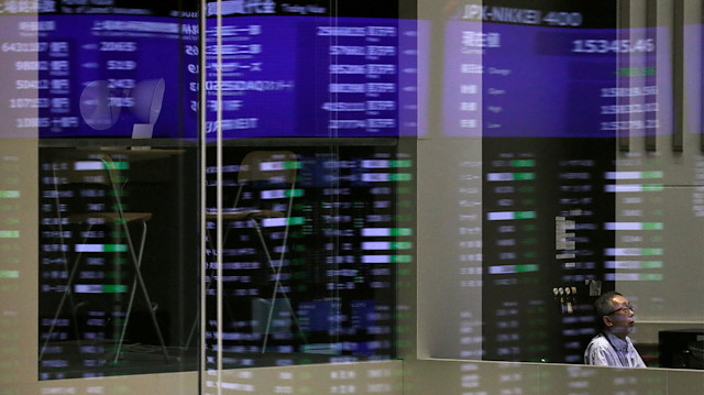 Market prices are reflected in a glass window at the Tokyo Stock Exchange (TSE) in Tokyo, Japan.