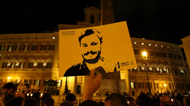 File photo: A man holds a placard during a vigil to commemorate Giulio Regeni, who was found murdered in Cairo a year ago, in downtown Rome, Italy