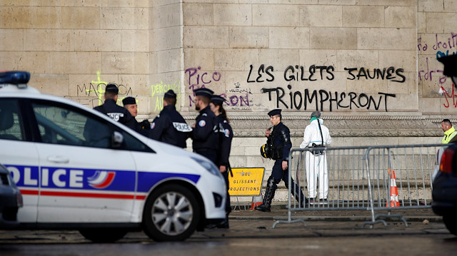 Cleanup operations continue under the message, "The Yellow Vests will Triumph" written on the Arc de Triomphe, the morning after clashes with protesters wearing yellow vests, a symbol of a French drivers' protest against higher diesel taxes, in Paris, France, December 2, 2018. 