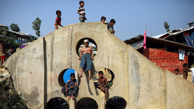 Rohingya refugee children play on a concrete structure at the Balukhali camp in Cox’s Bazar, Bangladesh

