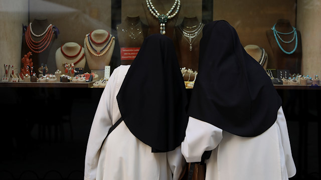 Catholic nuns look at a jewellery window display in Madrid, Spain