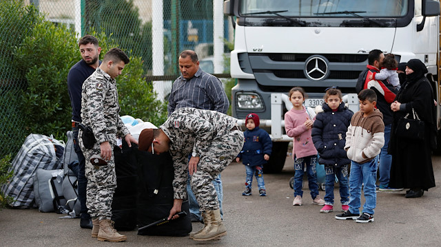 Lebanese general security members check luggage of Syrian refugees returning to Syria, in Beirut, Lebanon.