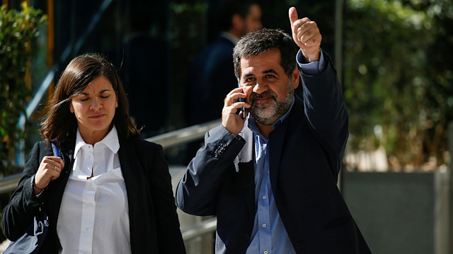 Jordi Sanchez, a Catalan separatist leader, gestures as he leaves Spain's High Court in Madrid.