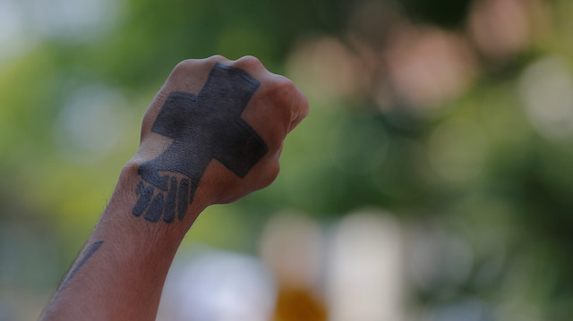 A man raises his tattooed fist at the site where Heather Heyer was killed, on the one-year anniversary of the 2017 white-nationalist "Unite the Right" rally in Charlottesville, Virginia, U.S., August 12, 2018