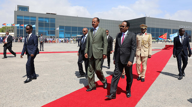 Eritrea's President Isaias Afwerki (L) is welcomed by Somalia's President Mohamed Abdullahi Mohamed as he arrives at the Aden Abdulle International Airport in Mogadishu, Somalia December 13, 2018