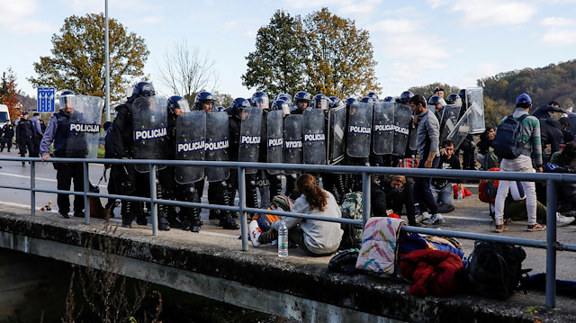 File photo: Croatian police stand guard in front of migrants at Maljevac border crossing 