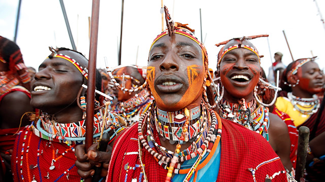 Maasai Moran athletes sing and dance as they arrive for the 2018 Maasai Olympics at the Sidai Oleng Wildlife Sanctuary, at the base of Mt. Kilimanjaro, near the Kenya-Tanzania border in Kimana, Kajiado, Kenya.