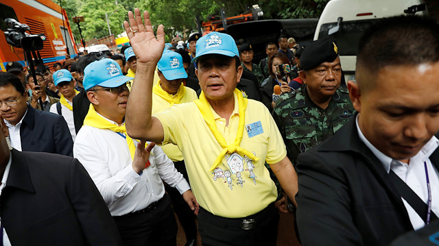 Thailand's Prime Minister Prayut Chan-o-cha waves as he arrives at the Tham Luang cave complex during an ongoing search for members of an under-16 soccer team and their coach, in the northern province of Chiang Rai, Thailand.