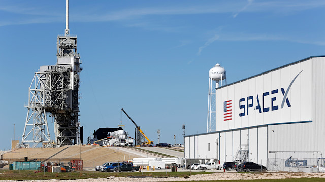 A SpaceX Falcon 9 rocket (in center, in a horizontal position), is readied for launch on a supply mission to the International Space Station on historic launch pad 39A at the Kennedy Space Center in Cape Canaveral, Florida, US.