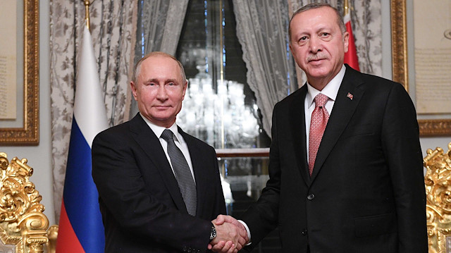 Russian President Vladimir Putin (L) shakes hands with his Turkish counterpart Tayyip Erdoğan 