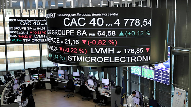 Stock index price for France's CAC 40 and company stock price information are displayed on screens as they hang above the Paris stock exchange, operated by Euronext NV, in La Defense business district in Paris, France.