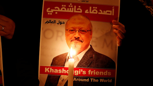 A demonstrator holds a poster with a picture of Saudi journalist Jamal Khashoggi outside the Saudi Arabia consulate in Istanbul, Turkey October 25, 2018.  