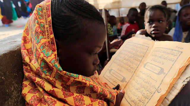 A girl learns to recite the Koran in a makeshift madrasa in Fass