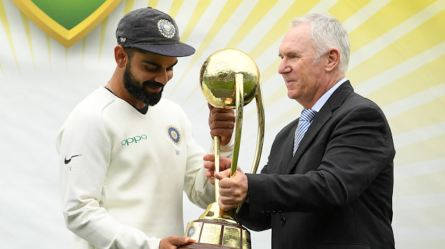 India's captain Virat Kohli recieves the Border-Gavaskar Trophy from Australia's former cricketer Allan Border following India's 2-1 series victory over Australia after play being abandoned on day five in the fourth test match between Australia and India at the SCG in Sydney, Australia, January 7, 2019. 