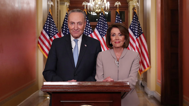 U.S. Speaker of the House Nancy Pelosi and Senate Minority Leader Chuck Schumer pose for photographers after concluding their joint response, to President Trump's prime time address, on Capitol Hill in Washington, U.S., January 8, 2019. 