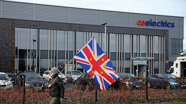 A pro-European Union demonstrator walks in front of a building where Jeremy Corbyn, leader of the Labour Party, delivers a speech on Brexit in Wakefield, Britain, 