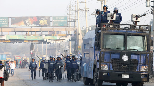 Police chase garments workers who have been protesting for higher wages, with water cannon at Ashulia, outskirt of Dhaka, Bangladesh, January 14, 2019. 