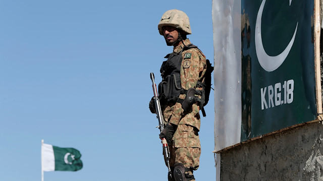A soldier stands guard at the Angoor Adda outpost
