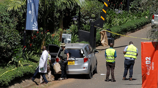 Kenyan policemen and explosives experts gather evidence from the car suspected to have been used by the attackers outside the scene where explosions and gunshots were heard at The DusitD2 complex, in Nairobi, Kenya.