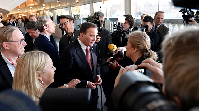Social Democrat leader Stefan Lofven is surrounded by journalists after being voted back as prime minister, in Stockholm, Sweden January 18, 2019. 