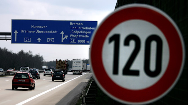 Cars pass a 120 km/h (75 mph) speed limit sign on the A27 Autobahn near the northern German city of Bremen.