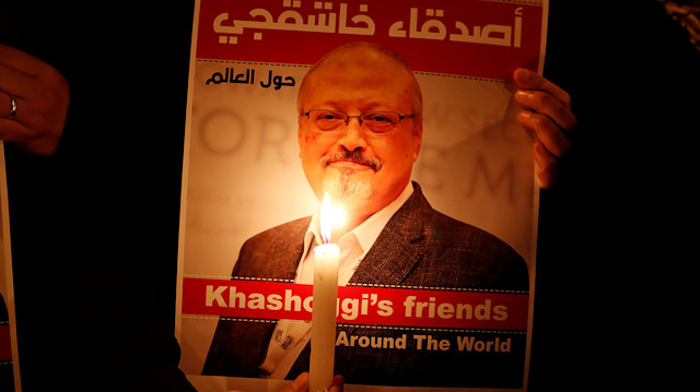 A demonstrator holds a poster with a picture of slain Saudi journalist Jamal Khashoggi