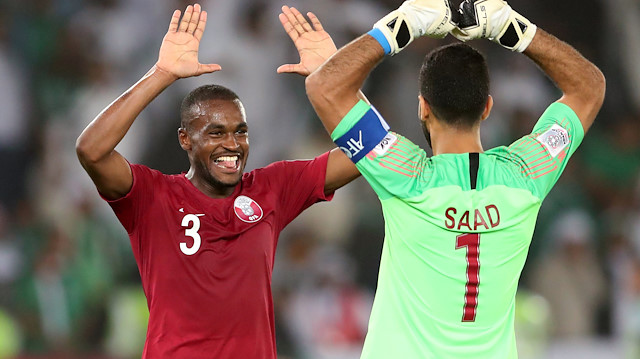 Qatar's Abdelkarim Hassan and Saad Al-Sheeb celebrate after the match
