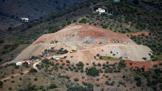 An idle drill (bottom) is seen next to diggers and trucks removing sand at the area where Julen, a Spanish two-year-old boy fell into a deep well six days ago when the family was taking a stroll through a private estate, in Totalan, southern Spain, January 19, 2019. 