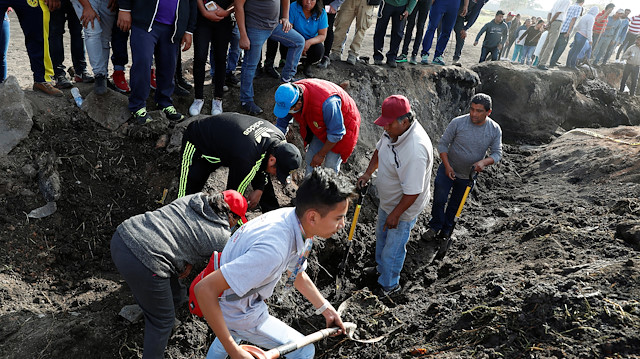 Residents search for human remains and items that could help to identify their missing relatives and friends at the site where a pipeline ruptured by oil thieves exploded, in the municipality of Tlahuelilpan, state of Hidalgo, Mexico.
