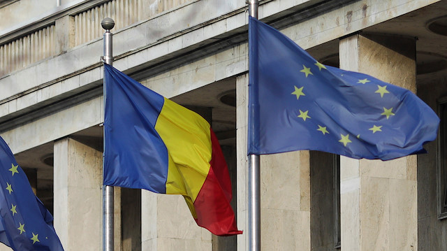 Romanian and EU flags are pictured