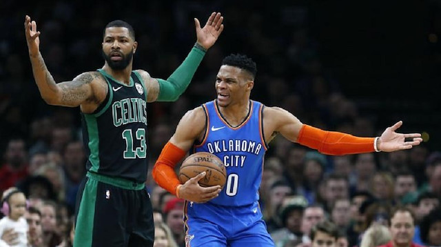 Oklahoma City Thunder's Russell Westbrook (0) protests a call beside Boston Celtics' Marcus Morris (13) during the first half of an NBA basketball game in Boston.