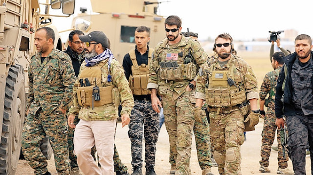 ABD askerleri PKK’lılarla kol kola görüntülenmişti.
