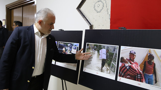 Kerem Kınık, head of the Turkish Red Crescent (Kızılay) shows pictures from a safe zone in Syria