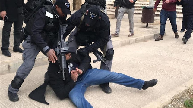 Israeli forces take a Palestinian into custody after shutting all gates of East Jerusalem's flashpoint Al Aqsa Mosque on February 18, 2019.