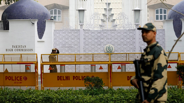 An armed policeman stands guard outside Pakistan High Commission in New Delhi, India