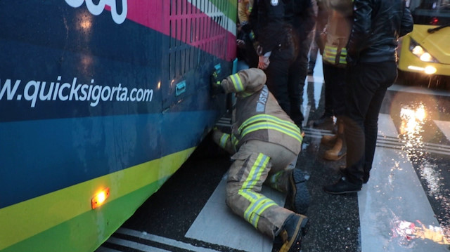 Polis ve itfaiye ekipleri, otobüsün altındaki adamı ikna etmeye çalıştı.