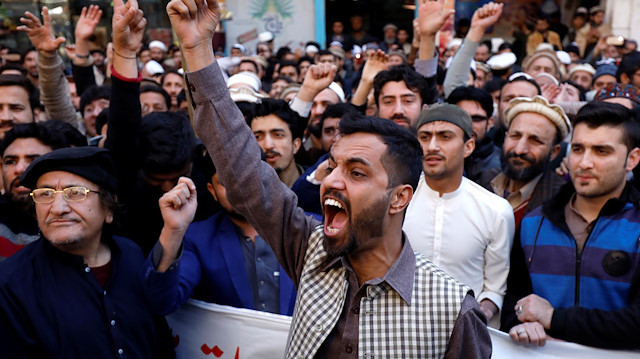 People chant slogans during a rally after Pakistan shot down two Indian military aircrafts