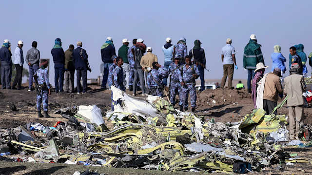 Ethiopian Federal policemen stand at the scene of the Ethiopian Airlines Flight ET 302 plane crash, near the town of Bishoftu, southeast of Addis Ababa, Ethiopia.