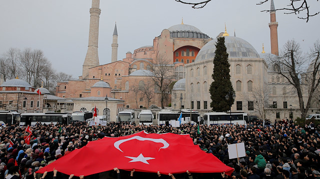 Demonstrators wave a Turkish flag during a protest against the Christchurch mosque attack in New Zealand, in front of the Hagia Sophia in Istanbul, Turkey 

