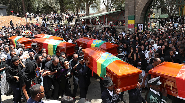 Pallbearers carry the coffins of the victims of the Ethiopian Airline Flight ET 302 plane crash