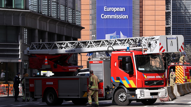 Firefighters secure an area after a bomb alarm in a building near to European Comission headquarters in Brussels, Belgium