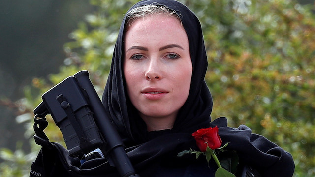 A policewoman is seen as people attend the burial ceremony of a victim of the mosque attacks, at the Memorial Park Cemetery in Christchurch, New Zealand March 21, 2019. REUTERS/Jorge Silva

