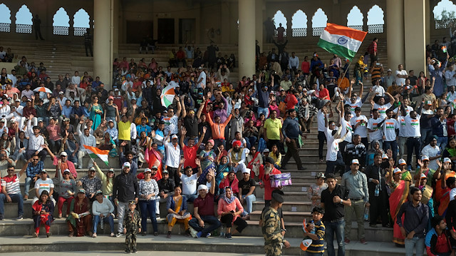 Indian spectators at a stadium at the Wagah-Attari border crossing cheer the 'friendship bus'