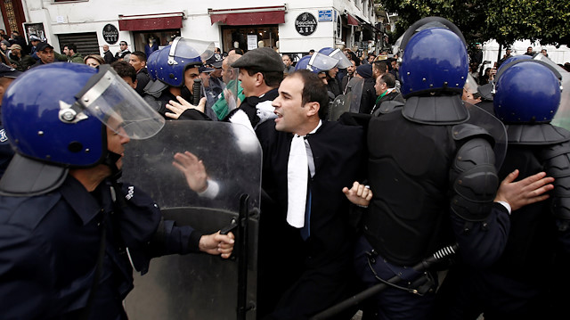 Police try to disperse lawyers marching during a protest to demand resignation of President Abdelaziz Bouteflika, in Algiers, Algeria March 23, 2019