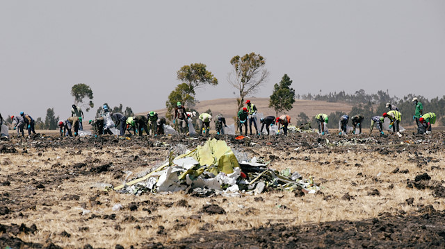 File photo: Ethiopians search for remains at the Ethiopian Airlines Flight ET 302 plane crash before a commemoration ceremony at the scene of the crash, near the town of Bishoftu, southeast of Addis Ababa