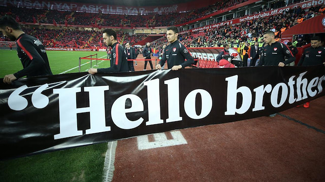 Turkish footballers hold 'Hello Brother' banners