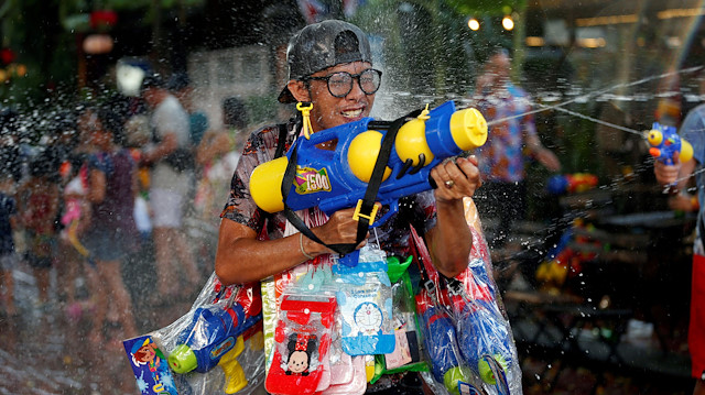 People play with water pistols during Songkran Water Festival to celebrate Thai New Year, in Bangkok, Thailand April 14, 2018.