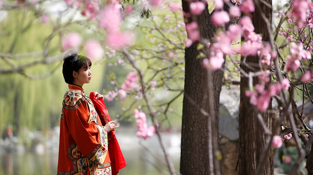 Women dressed in traditional costumes are seen during the Qingming tomb ...